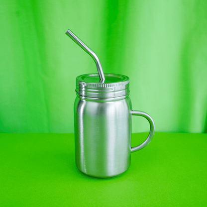 Stainless steel mason jar style 500ml smoothie cup with handle and straw on a green background